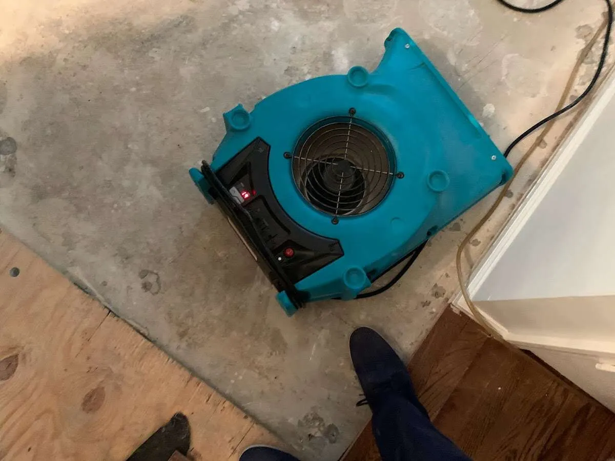 Air mover drying subfloor during Commercial Water Damage Restoration in Ocean Pines